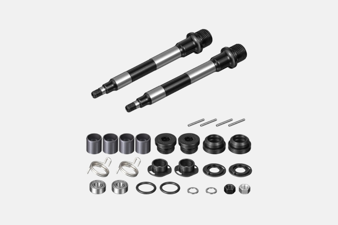 A collection of mechanical components including two threaded axles with a black and silver finish, various cylindrical spacers, washers, bearings, and several small pins and clips arranged in a neat layout.