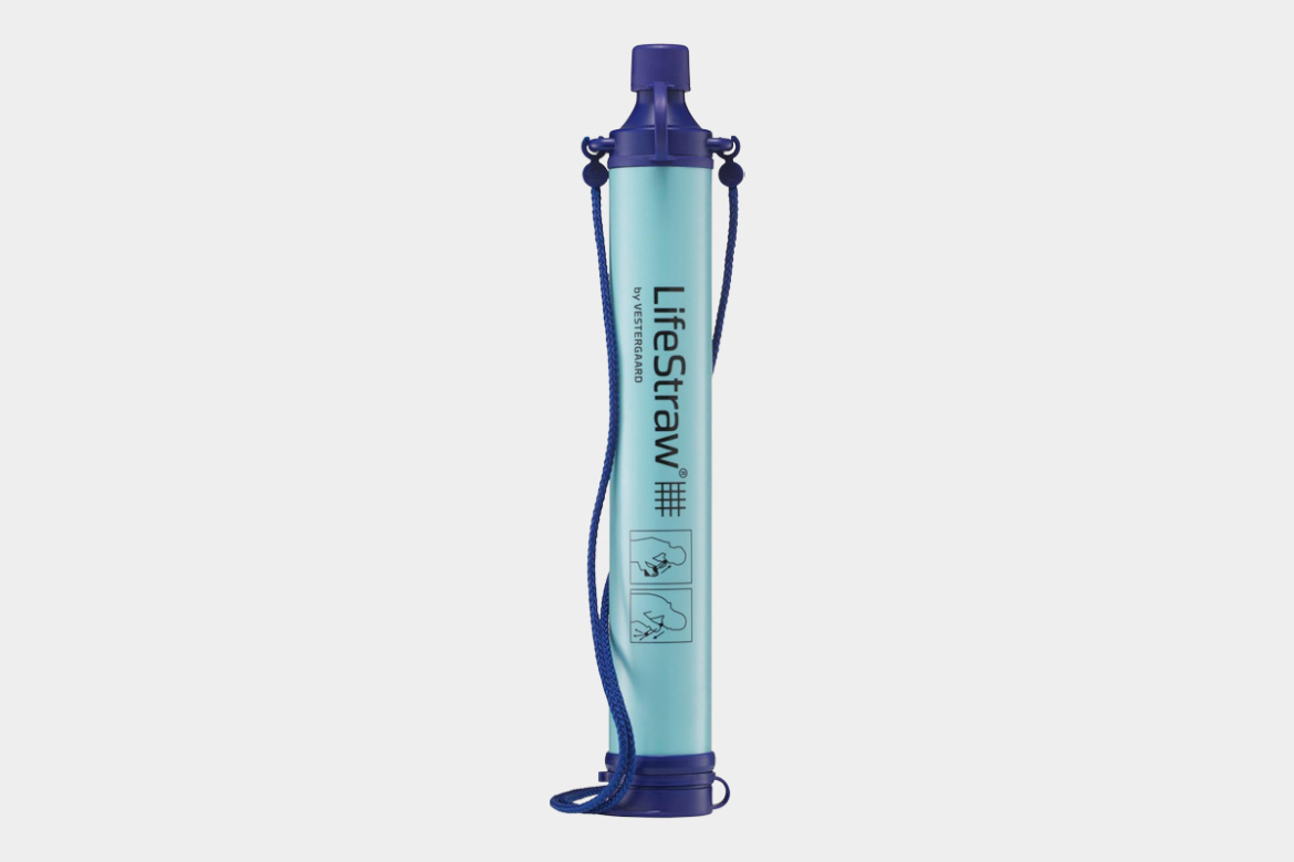 Image of a LifeStraw water filter, featuring a long, cylindrical design with a light blue body and dark blue accents. The product includes hanging attachments and illustrated instructions on the side for use.
