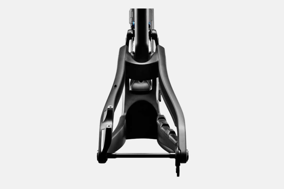 A close-up view of a bicycle frame taken from a low angle, highlighting its sleek design and structural features. The frame is primarily black with aesthetic curves and elements like the rear triangle and seat post visible, against a neutral background.