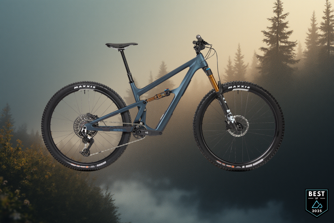 A high-quality mountain bike showcased against a misty forest backdrop, featuring a sleek gray frame with gold accents, disc brakes, and Maxxis tires. The design highlights modern mountain biking technology, with a focus on performance and durability. A badge reading "Best of 2025" is positioned in the lower right corner.