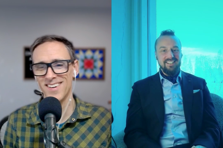 Two men are featured in a split-screen video call. On the left, a man with short hair and glasses is smiling and wearing a green and black checkered shirt, with a microphone in front of him. On the right, a man with a beard and a mohawk hairstyle is dressed in a dark suit over a light blue shirt, seated comfortably in an armchair with a window showing a snowy landscape behind him. The background has a bright, cool-toned aesthetic.