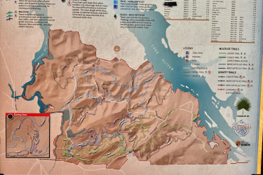 Map of Standing Boy Trails showing various hiking and biking trails around Lake Oliver. The map includes detailed descriptions of trail difficulties, with color-coded difficulty levels (green for easy, blue for moderate, and black for difficult), trailhead locations, and safety information. A small inset map provides a zoomed-in view of a specific area. Additional notes on trail maintenance and emergency contact information are also included. Standing Boy Trails mountain bike trail.