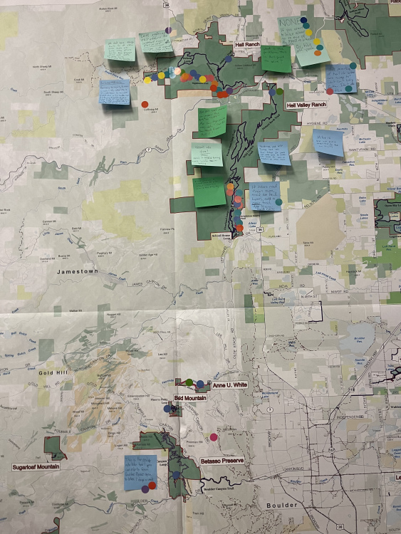 A detailed map showing various locations, including Hall Ranch, Sugarloaf Mountain, and Betasso Preserve, marked with colorful sticky notes and dots indicating points of interest or comments. The map displays geographic features, trails, and nearby towns with a variety of colors highlighting different areas.