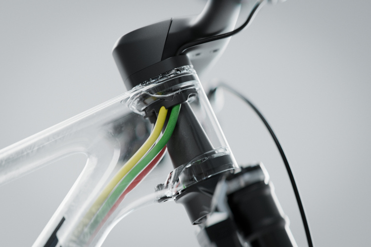 Close-up view of a bicycle's head tube featuring integrated cable management with multicolored wires (yellow, green, and red) and a sleek, modern design. The image highlights the connection between the handlebar and the frame, showcasing the craftsmanship of the bike's construction.
