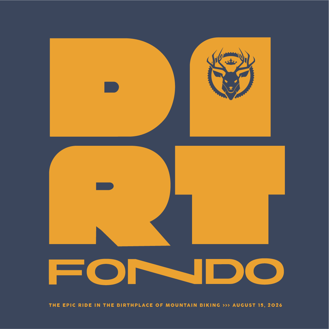 Logo design for a biking event featuring bold, stylized text that reads "DIRT FONDO." Above the text, there is an emblem of a deer within a gear, hinting at a connection to mountain biking. The color scheme includes orange on a dark blue background. Below the main text, additional details read: "THE EPIC RIDE IN THE BIRTHPLACE OF MOUNTAIN BIKING »» AUGUST 15, 2026."