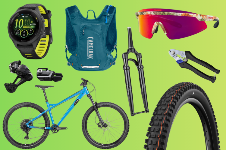 A collection of mountain biking gear displayed on a gradient green background, including a Garmin smartwatch, a blue CamelBak hydration pack, colorful sunglasses, bicycle components like a fork and derailleur, a multi-tool, a blue mountain bike, and a black tire.