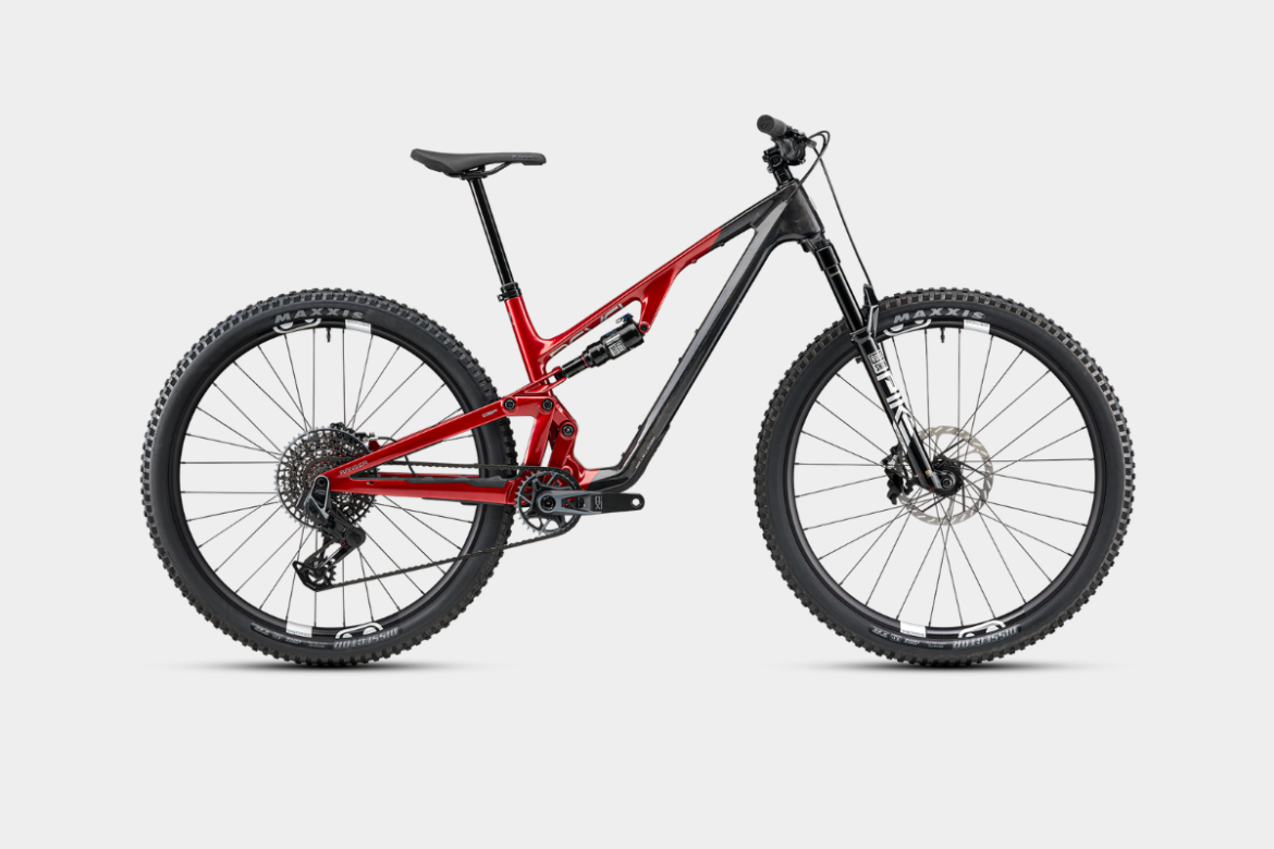 A modern mountain bike featuring a sleek frame with a combination of red and black colors, dual suspension, wide tires, and disc brakes, positioned against a plain background.