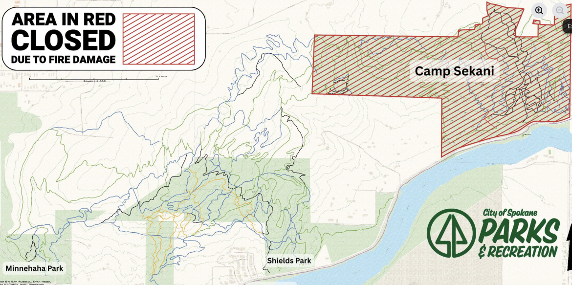 A map showing designated areas of Spokane, with sections highlighted in red indicating closures due to fire damage. The map marks Camp Sekani and includes landmarks such as Minnehaha Park and Shields Park, along with topographical lines illustrating elevation changes. The logo of Spokane Parks & Recreation is displayed at the bottom right.