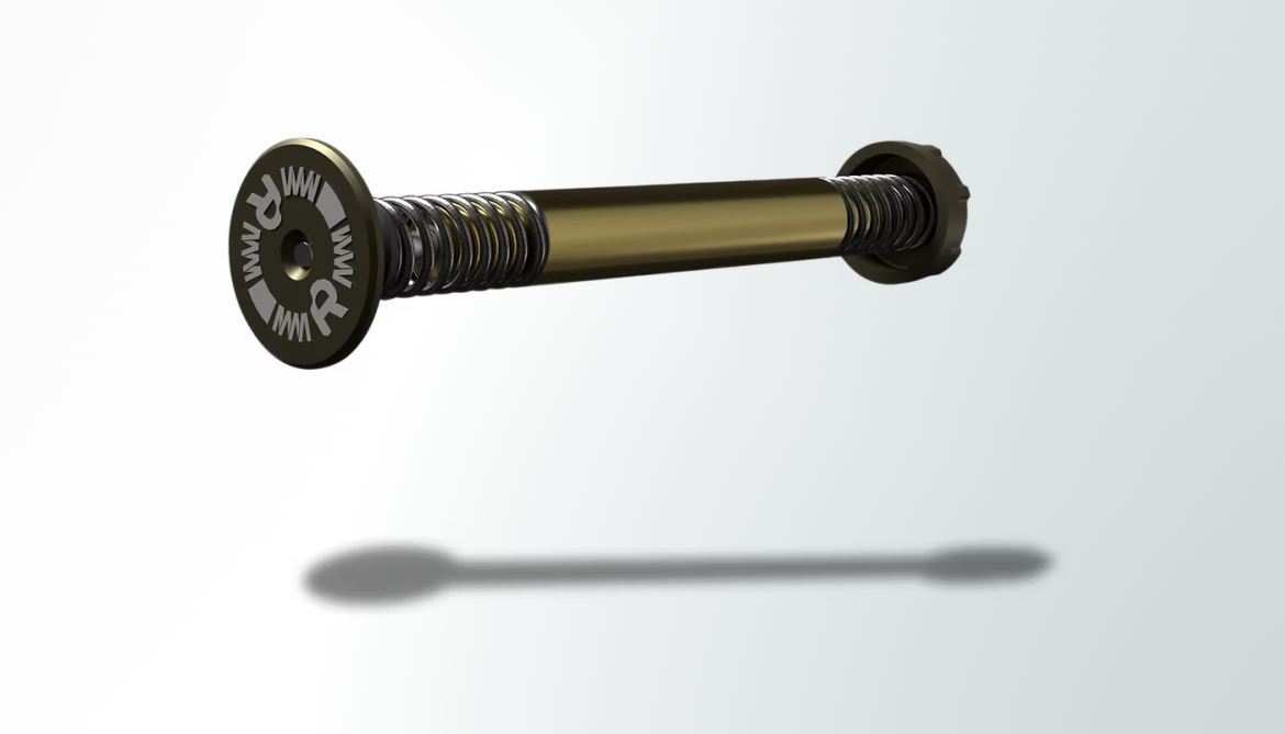 A close-up view of a metallic screw with a coiled spring design, featuring a round head with an emblem or logo on top and a smooth shaft. The background is a soft gradient, enhancing the focus on the screw. A shadow is cast on the surface below.