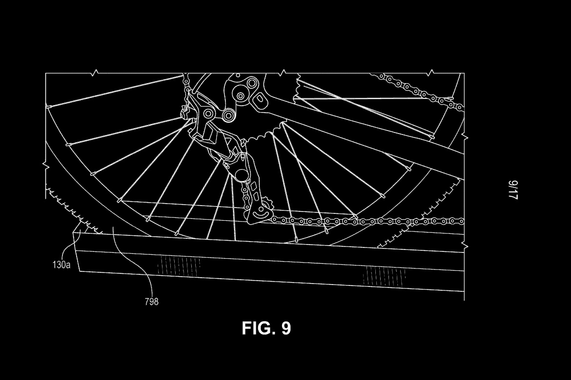 Black and white technical drawing of a bicycle rear wheel, showcasing the gears, chain, and derailleur mechanism. The image includes labeled components and a reference to "FIG. 9" at the bottom.