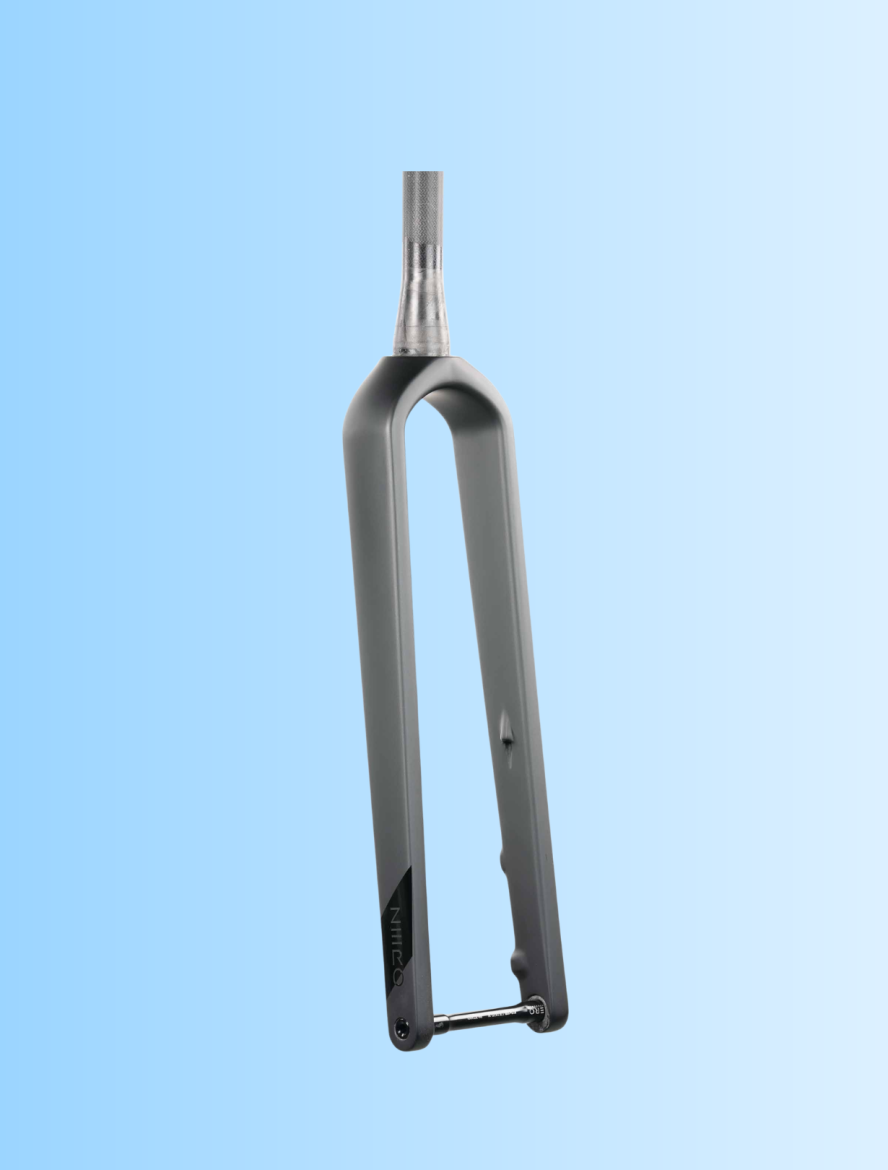 A bicycle fork displayed against a light blue background, featuring a sleek gray design with a smooth finish and a threaded top section. The fork is shown from the front view, emphasizing its streamlined shape and structural elements.
