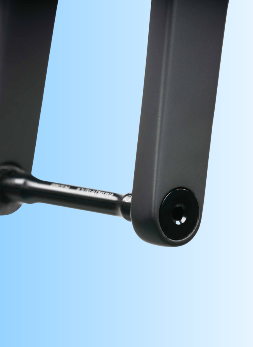 Close-up view of a black, matte-finished mechanical component with a sleek design, featuring a circular fastening point and a connecting rod, set against a light blue gradient background.
