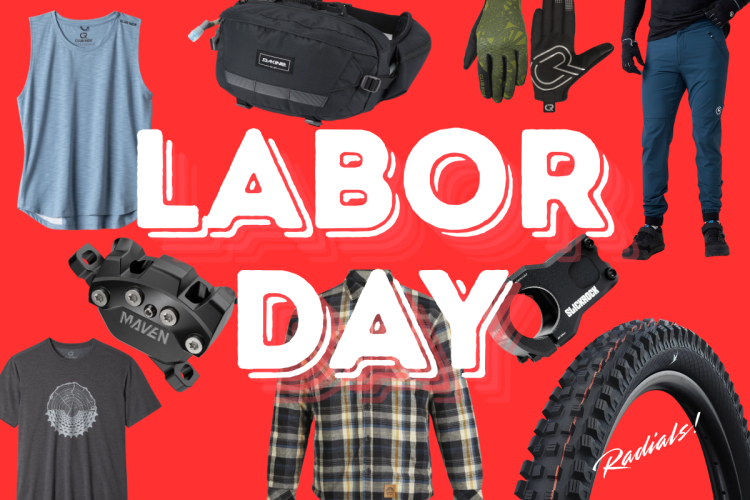 Red background with the text "LABOR DAY" prominently displayed in large, white, bold letters. Surrounding the text are various outdoor and cycling-themed products including: a blue sleeveless shirt, a black waist pack, green patterned gloves, a grey graphic t-shirt, a plaid flannel shirt, a black bike part labeled "MAVEN," a black bicycle component, dark blue pants, and a mountain bike tire.
