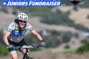 A smiling cyclist riding a mountain bike on a dirt trail with a blurred background of hills. The image includes bold text that reads "Stafford Lake Rattler XC + Juniors Fundraiser" and the date "November 8, 2026." The cyclist is wearing a helmet and sports gear.