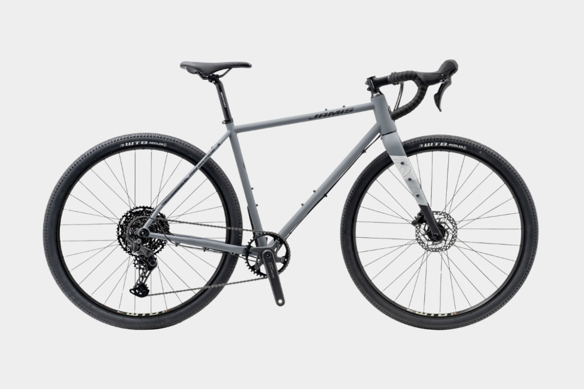 A modern gray bicycle with a sleek design, featuring drop handlebars, disc brakes, and rugged tires suitable for off-road cycling. The bike showcases a single front chainring and a rear cassette system, emphasizing its versatility for both road and trail use.